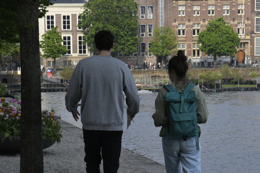 participant in conversation with one of the artists while the group walks