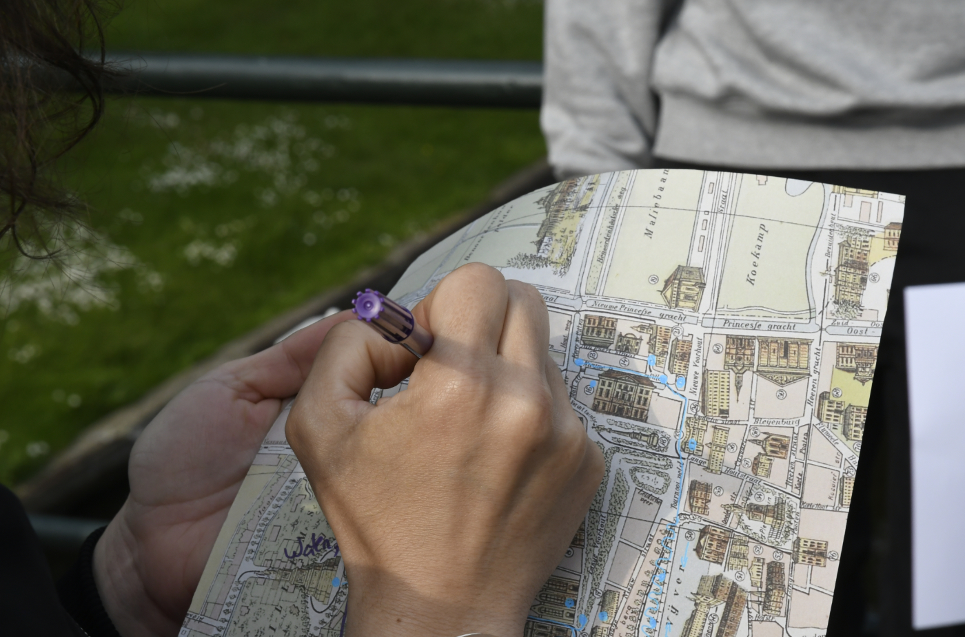 photo taken during public walk, audience member drawing on a map